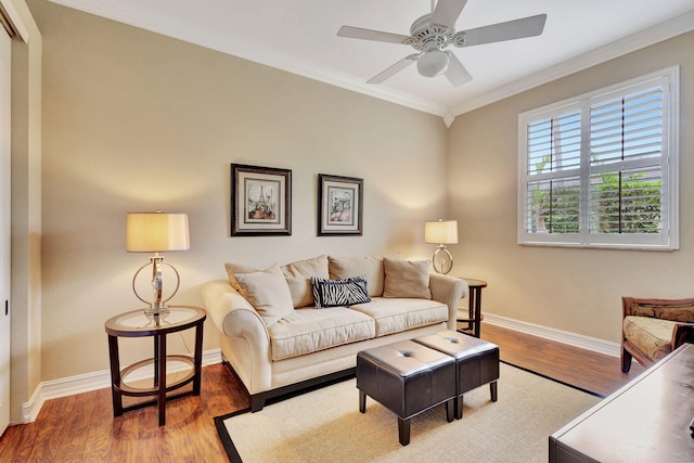 living room with wood-type flooring, crown molding, and ceiling fan