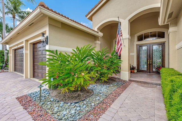 property entrance featuring french doors and a garage