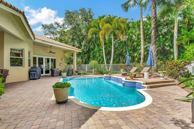 view of swimming pool with a patio, area for grilling, ceiling fan, and french doors