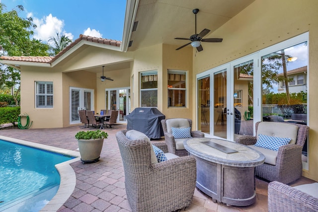 view of patio / terrace with area for grilling, ceiling fan, and french doors