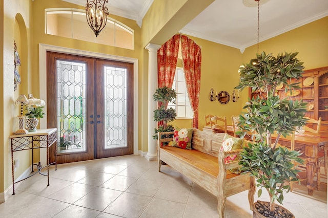 entrance foyer featuring ornamental molding, plenty of natural light, and french doors