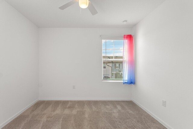 empty room with ceiling fan and light colored carpet