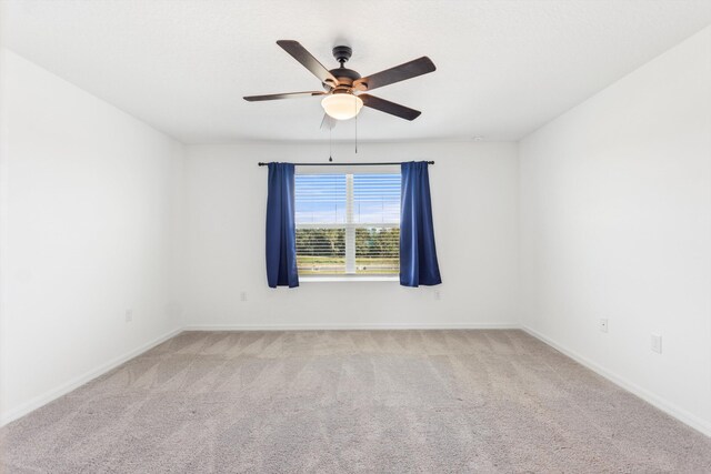 unfurnished room featuring ceiling fan and light carpet