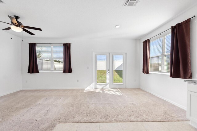 empty room with ceiling fan and light colored carpet