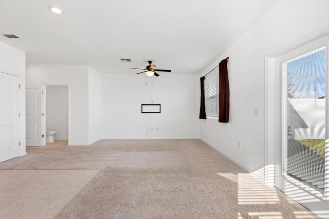 carpeted spare room featuring ceiling fan