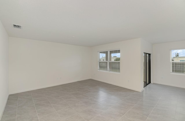 unfurnished room with visible vents and baseboards