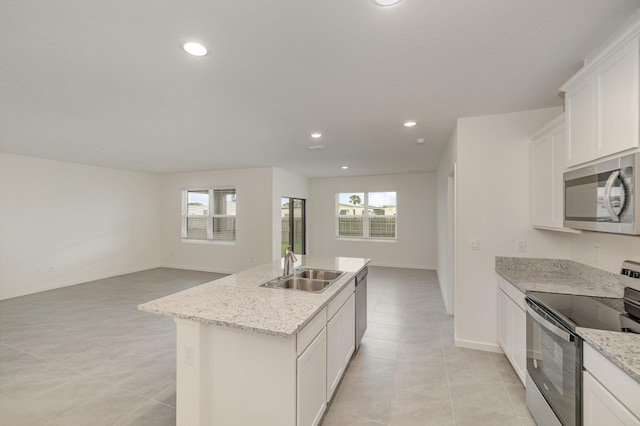 kitchen featuring a sink, an island with sink, appliances with stainless steel finishes, and a healthy amount of sunlight