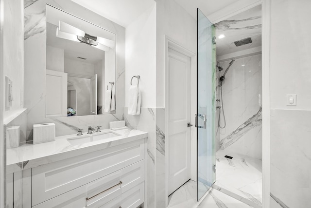 bathroom with vanity and a shower with door