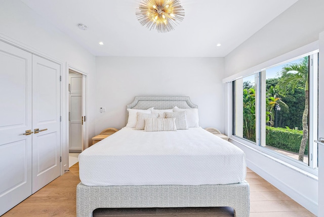 bedroom with light wood-type flooring and a closet