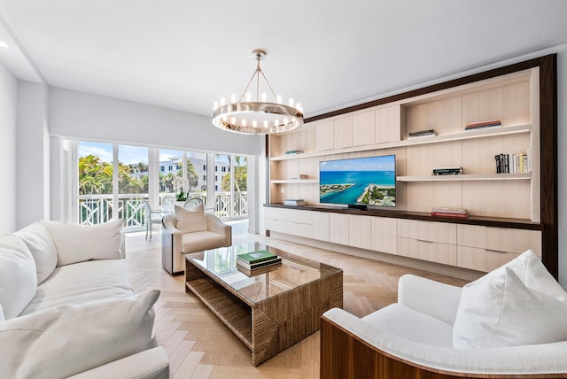 living room featuring a notable chandelier and light parquet flooring