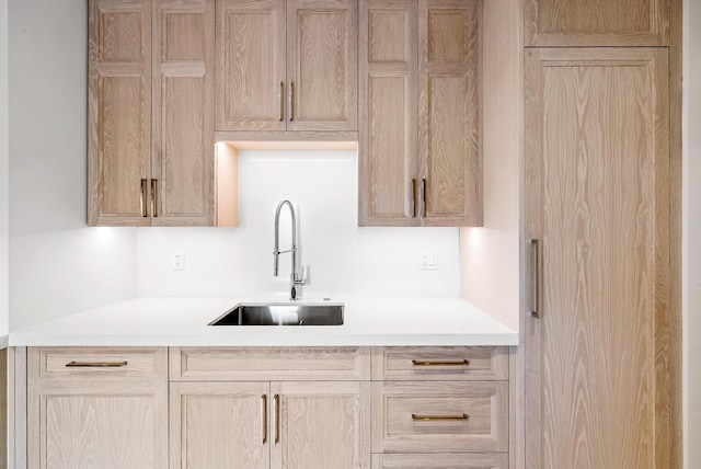 kitchen featuring light brown cabinetry and sink