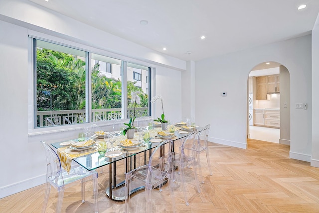 dining space with light parquet floors