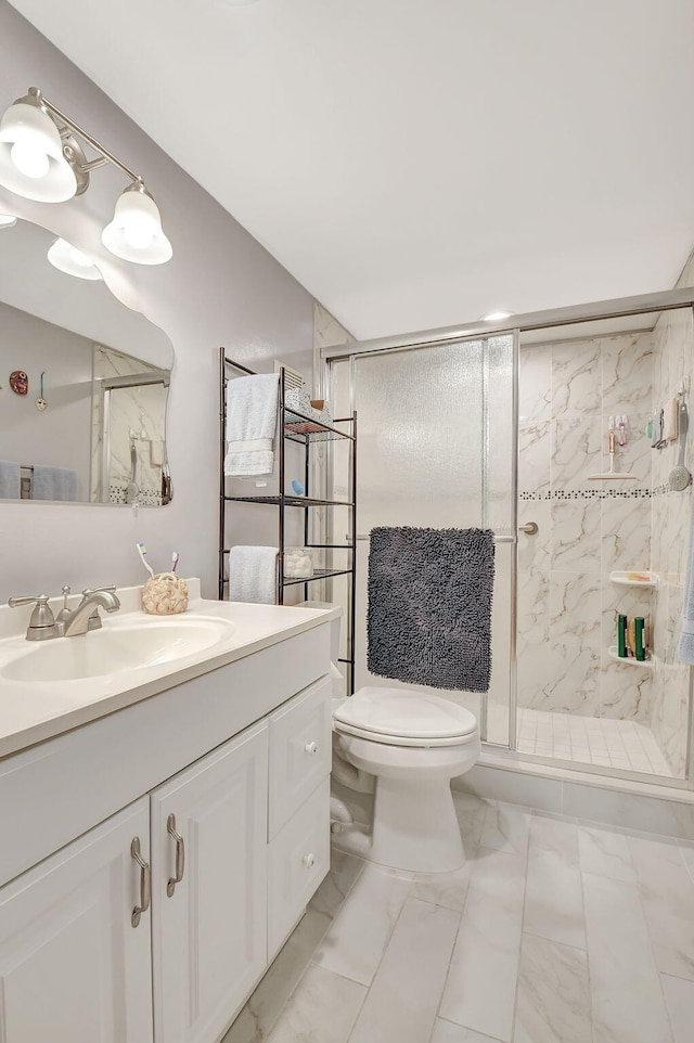 bathroom with toilet, a stall shower, vanity, and marble finish floor