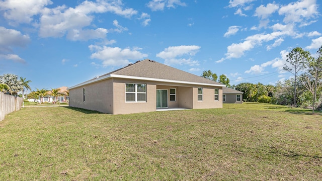 back of property featuring a yard