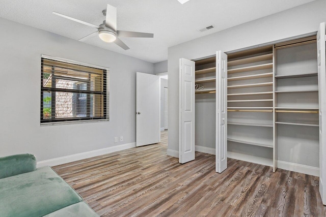 interior space featuring wood-type flooring and ceiling fan