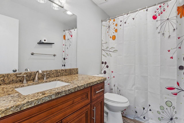 bathroom featuring wood-type flooring, vanity, toilet, and a shower with shower curtain