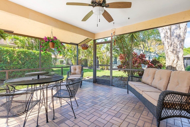 sunroom / solarium featuring a wealth of natural light and ceiling fan