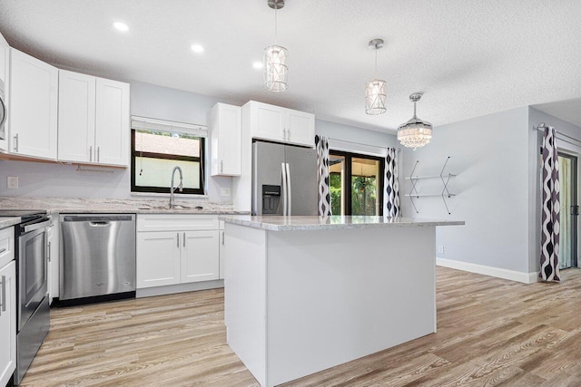 kitchen featuring sink, stainless steel appliances, and white cabinets