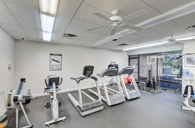 gym featuring a drop ceiling and ceiling fan