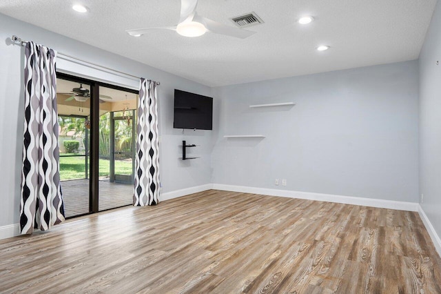 unfurnished room featuring ceiling fan, a textured ceiling, and light hardwood / wood-style flooring