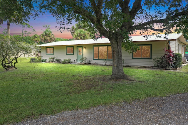 ranch-style house with a yard