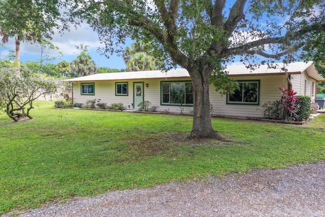 ranch-style home featuring a front yard