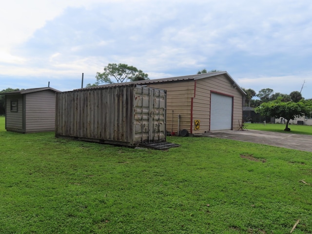 view of outbuilding featuring a garage and a yard