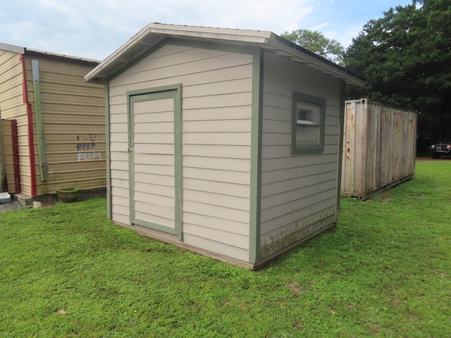 view of outbuilding with a lawn