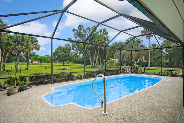 view of pool featuring glass enclosure, a lawn, and a patio area