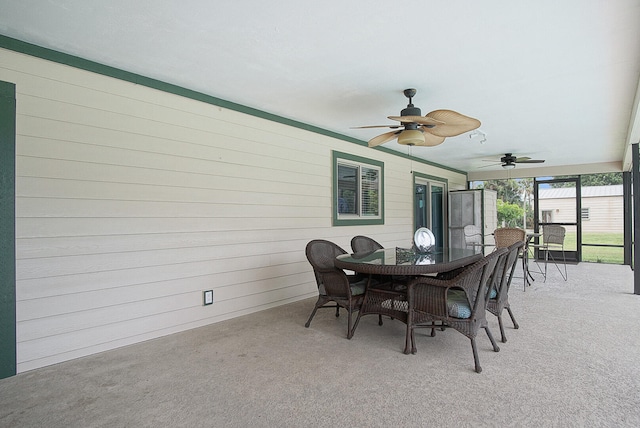 exterior space with wooden walls and ceiling fan