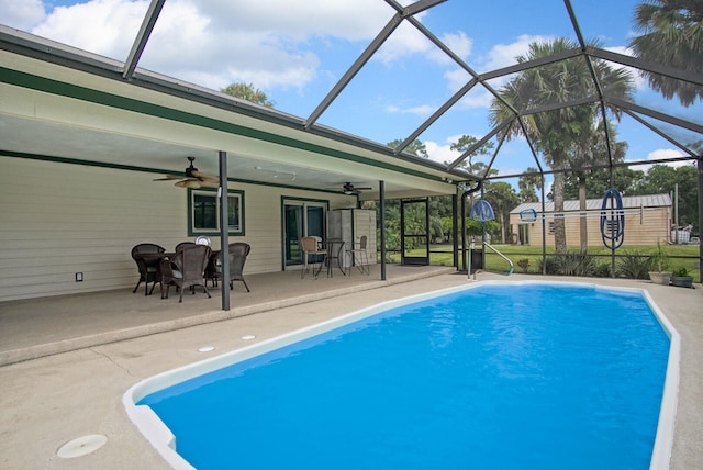 view of swimming pool with a patio, a storage unit, a lanai, and ceiling fan