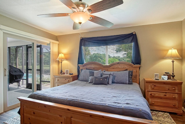 bedroom with wood-type flooring, ceiling fan, and access to exterior