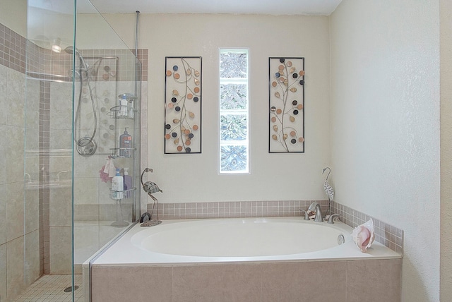 bathroom with shower with separate bathtub and plenty of natural light