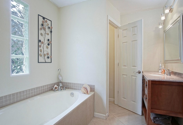 bathroom with vanity, tile patterned flooring, and a washtub