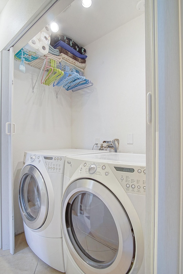 washroom featuring light tile patterned floors and washer and dryer