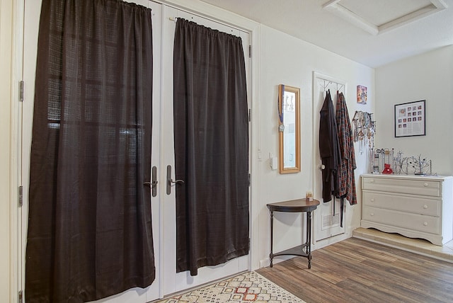 foyer entrance with a textured ceiling and dark hardwood / wood-style floors