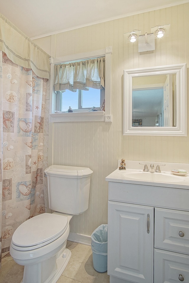 bathroom with tile patterned flooring, wood walls, a shower with shower curtain, vanity, and toilet