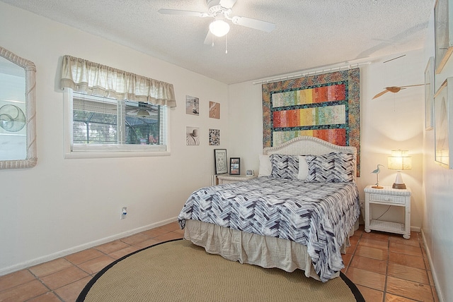 tiled bedroom featuring a textured ceiling and ceiling fan