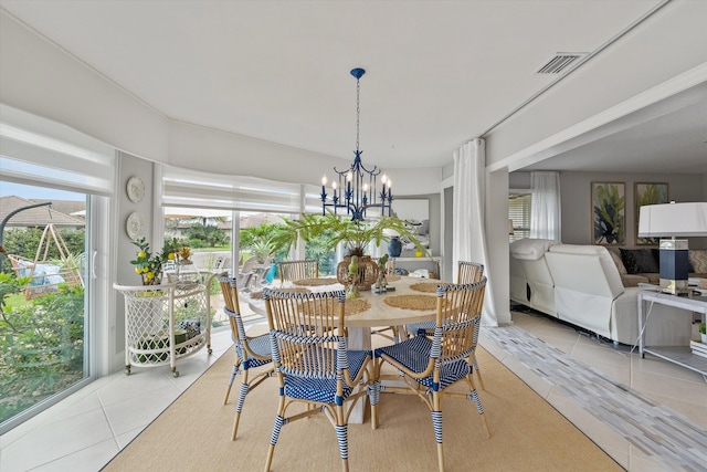 dining area featuring a chandelier and light tile patterned floors