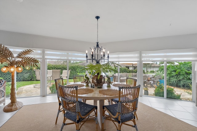 dining room with light tile patterned floors and an inviting chandelier