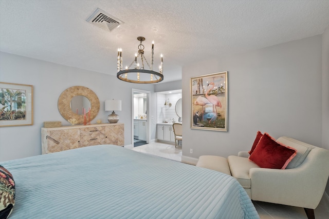 tiled bedroom with connected bathroom, a textured ceiling, and a notable chandelier