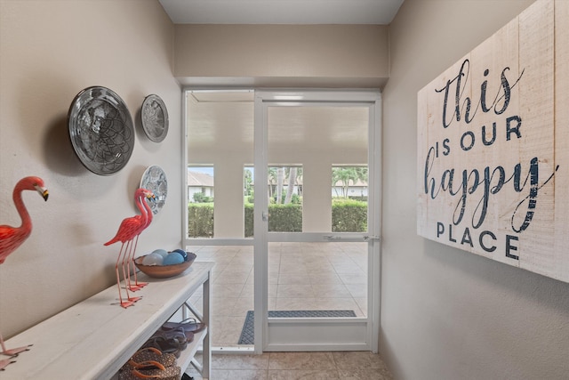 entryway featuring plenty of natural light and light tile patterned flooring