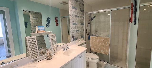 bathroom with vanity, toilet, and an enclosed shower