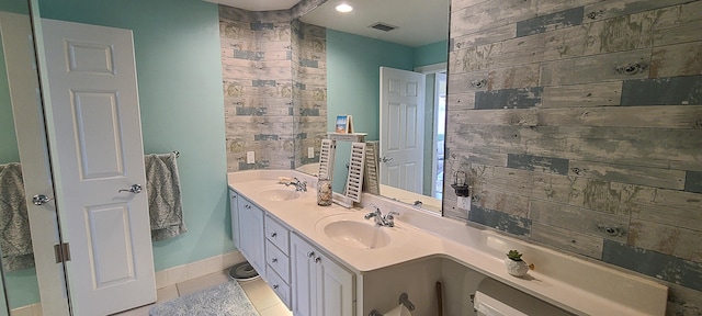 bathroom featuring tile patterned flooring and vanity