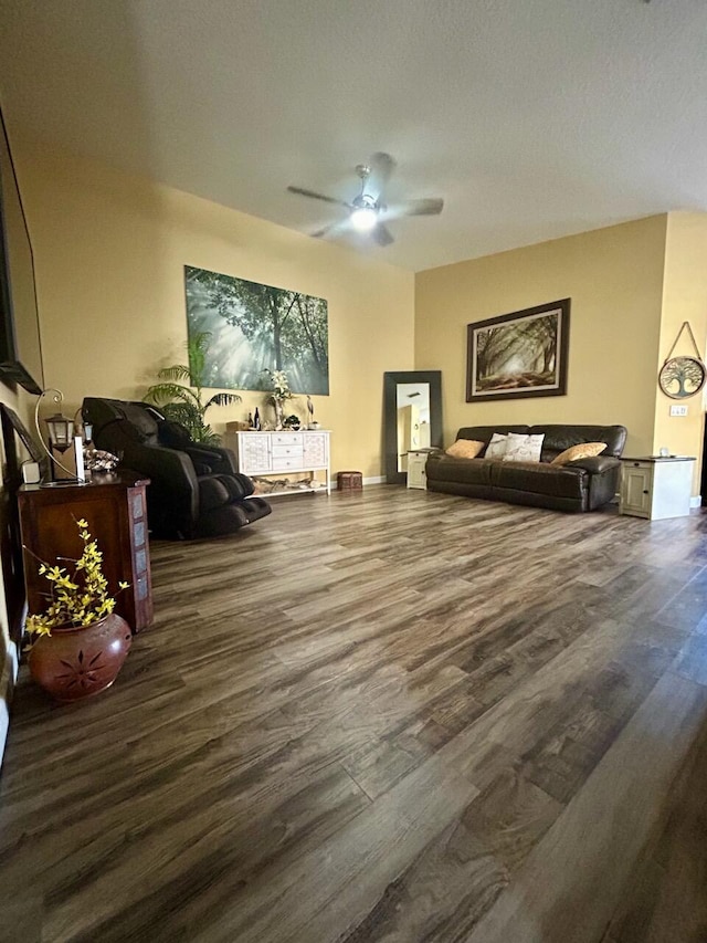 living room with wood-type flooring and ceiling fan