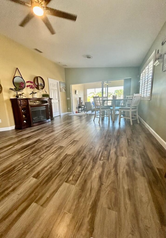 living room featuring wood-type flooring and vaulted ceiling