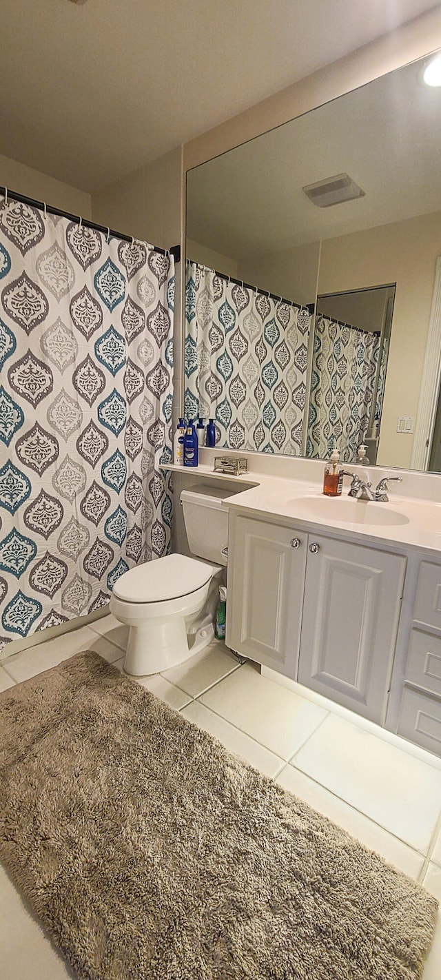 bathroom with tile patterned flooring, vanity, and toilet