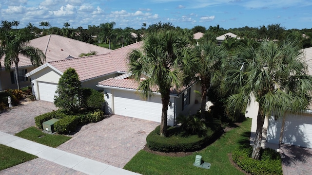 view of front of house with a garage and a front lawn