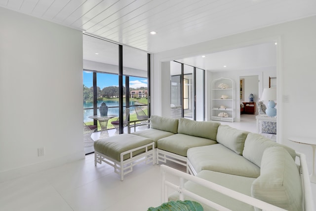 living room featuring wood ceiling and a water view