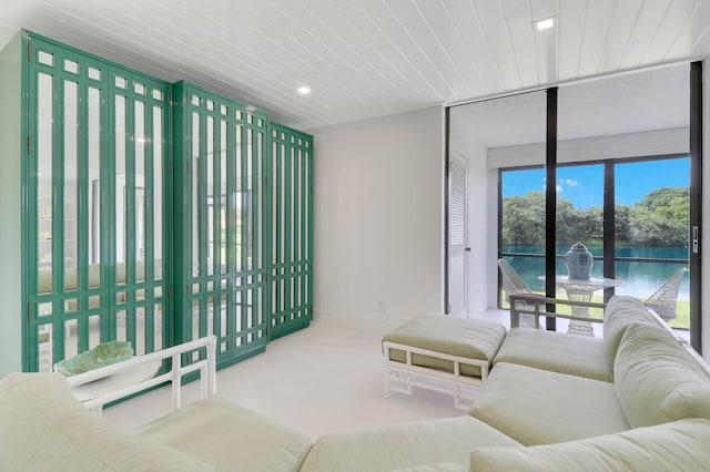 living room with carpet flooring and a water view